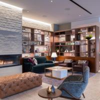 a living room with a fireplace and furniture at The Colonnade Hotel, Boston