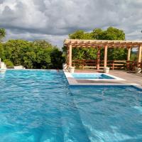 a large swimming pool with a wooden pergola and a swimming pool at Pousada Portalcion, Goiás
