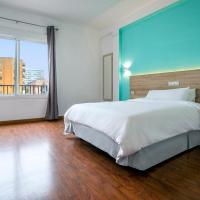 a bedroom with a large bed and a large window at Hotel Torremolinos Centro