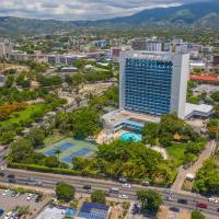 an aerial view of a city with a tall building at The Jamaica Pegasus Hotel, Kingston