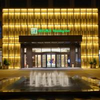 a building with a fountain in front of it at Holiday Inn Kunshan, an IHG Hotel