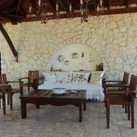 a living room with a bed and a table and chairs at Villa Niovi, Lagomandra