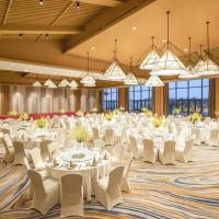 a large banquet hall with white tables and chairs at Holiday Inn Kunshan Huaqiao, an IHG Hotel
