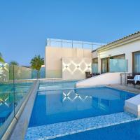 a villa with a swimming pool and a house at Castello Boutique Resort & Spa - Adults Only, Sisi