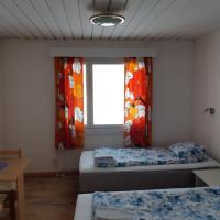 a room with two beds and a window at Matkakoti, Motel Kieppi Kuhmo