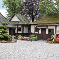 a house with a gravel driveway in front of it at Den Japanske Have B & B, Herning
