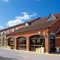 a large brick building with a store front at Holiday Inn Norwich North, an IHG Hotel