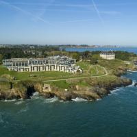 an island in the ocean with a large building at Emeria Dinard Hotel Thalasso & Spa