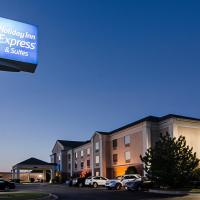a sign for a hotel with cars parked in front of a building at Holiday Inn Express Hotel & Suites Vinita, an IHG Hotel