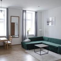 a living room with a green couch and a table at Apartament Mickiewicza, Wadowice