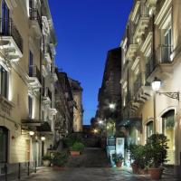 an alleyway between two buildings at night at Il Principe Hotel Catania