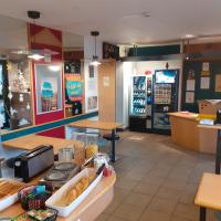 a fast food restaurant with a donut shop with a counter at hotelF1 Epinal Nord, Épinal