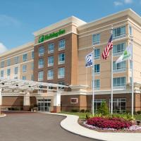 a hotel building with flags in front of it at Holiday Inn Indianapolis Airport, an IHG Hotel