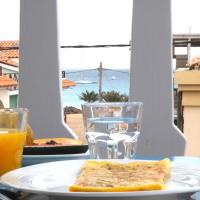 a plate with a piece of toast and a glass of orange juice at Hotel MiraBela, Santa Maria