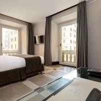 a hotel room with a bed and a large window at Best Western Plus Hotel Universo, Rome