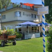 a house with flowers in a wagon in front of it at Hotel Brigitte, Bad Krozingen