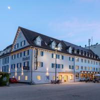 a large white building with a black roof at Hotel Messmer, Bregenz