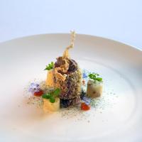 a white plate with a piece of food on it at Geniesserhotel Alpin GmbH, Achenkirch