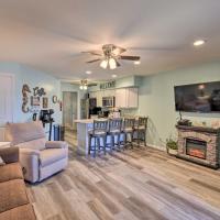 a living room with a couch and a fireplace at Waterfront Lake Delton Condo with Pool and Spa Access!