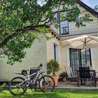 a bike parked in front of a house with an umbrella at Chalupa U Miška, Hybe