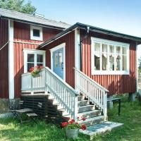 a small red house with stairs and a porch at Hannaksen tila, Korppoo