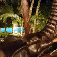 a statue of an animal with tusks in front of a pool at Boutique Hotel Nyumbani Tembo, Watamu