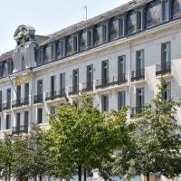 a white building with trees in front of it at Le Grand Hotel, Tours
