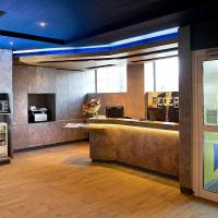 a lobby of a restaurant with a counter and a kitchen at Ibis Budget Strasbourg Centre Gare