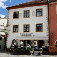 a large white building with a sign on it at Hotel Grand, Český Krumlov