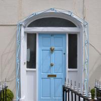 a blue door on a house with two baskets at Mulgrave Lodge, Dun Laoghaire