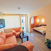 a living room with a couch and a bed and a television at Family Hotel Gran Ivan, Varna City