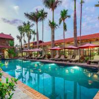 a pool at a hotel with palm trees and umbrellas at Tam Coc Banana Bungalow, Ninh Binh
