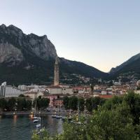 a city with a town and mountains in the background at Hotel Alberi, Lecco
