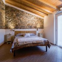 a bedroom with a bed and a brick wall at La corte dei tre, Torre del Lago Puccini