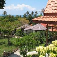 a house with a red roof and a garden at Thai Dee Garden Resort, Haad Rin