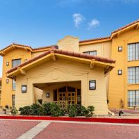 a large yellow building with a red road in front of it at La Quinta Inn by Wyndham El Paso West