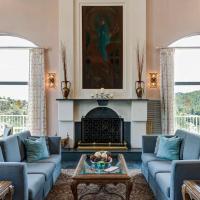 a living room with blue couches and a fireplace at Forest Villas Hotel, Prescott