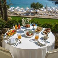 a white table with food on it with a view of the ocean at Grotta Palazzese Beach Hotel, Polignano a Mare