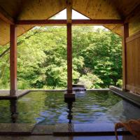 a pool of water in a pavilion with trees at Bettei Senjyuan, Minakami