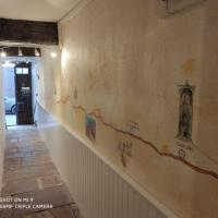 a hallway with a wall with drawings on it at Gîte Le Chemin vers l'Etoile, Saint-Jean-Pied-de-Port