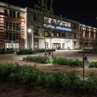 an university building at night with a sign on it at Van der Valk Hotel Apeldoorn
