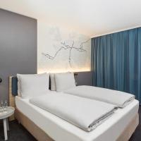 a bedroom with a white bed with a blue curtain at H4 Hotel Leipzig