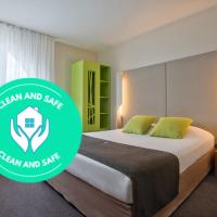 a hotel room with a bed with a green logo at Campanile Łódź