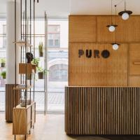 a lobby with a pru sign on the wall at PURO Wrocław Stare Miasto