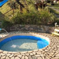 a small pool with a water fountain in a yard at Pousada Chácara do Rio, Lumiar