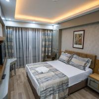 a small bedroom with a bed and a television at Lion City Hotel Kizilay, Ankara