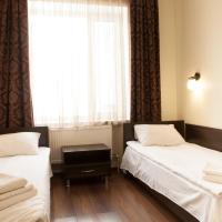two beds in a room with a window at Solar, Kropyvnytskyi