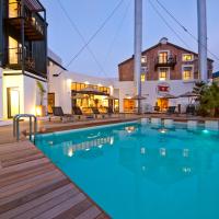 a pool with a wooden deck next to a building at Turbine Hotel & Spa, Knysna