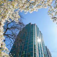 a tall building with white flowers in front of it at Rosedale on Robson Suite Hotel, Vancouver
