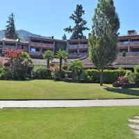 a resort with a green lawn and a building at Locazione Turistica Hermitage-5, Porto Valtravaglia